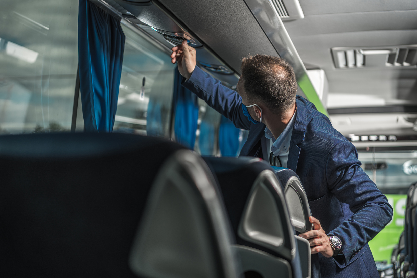 Shuttle Driver Checking Air Conditioning System in Bus